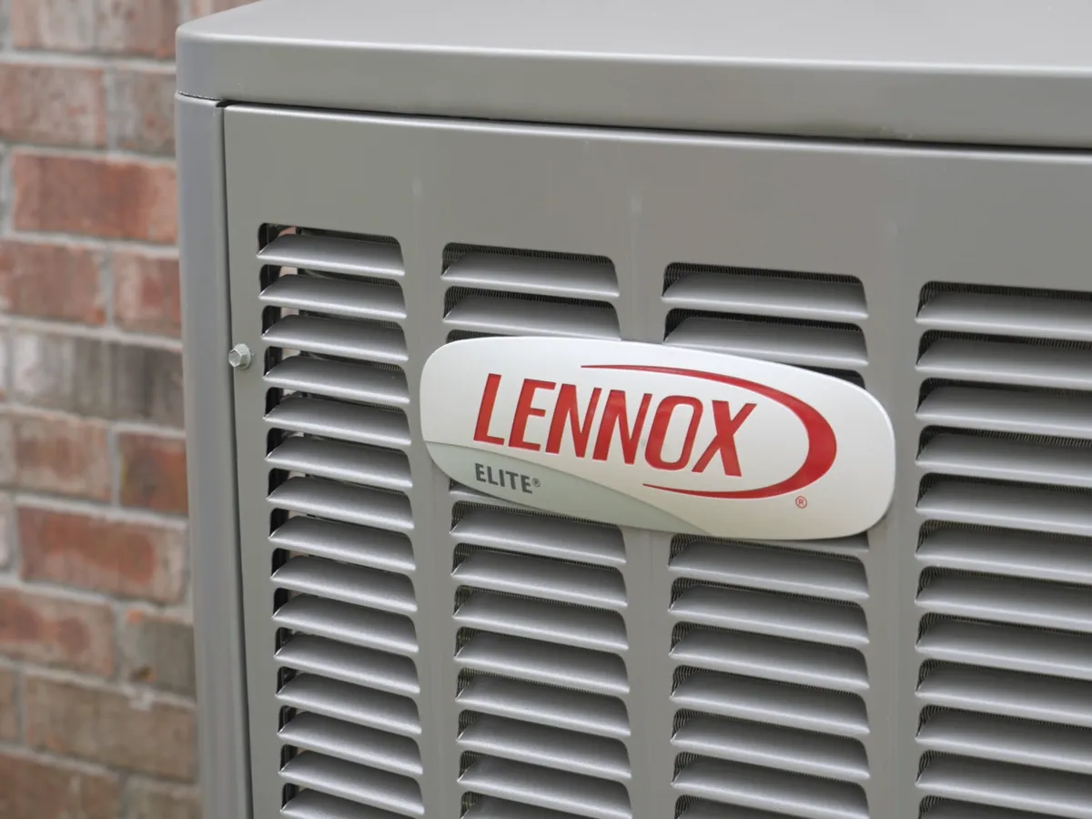 A Lennox outdoor unit beside a brick house