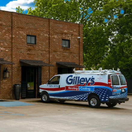 A Gilley's van parked beside a brick building